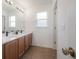 Bathroom features double sink vanity with ample countertop and modern lighting at 3025 Chessington Dr, Land O Lakes, FL 34638