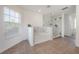 Bright bathroom featuring a glass enclosed shower and separate tub with elegant marble tile at 3025 Chessington Dr, Land O Lakes, FL 34638