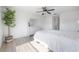 Bright bedroom with white walls, wood floors, and ceiling fan at 3025 Chessington Dr, Land O Lakes, FL 34638