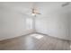 This bedroom features neutral walls, wood-look floors, a ceiling fan, and a double door closet at 3025 Chessington Dr, Land O Lakes, FL 34638