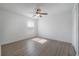 Well lit bedroom features wood-look floors, closet, and a ceiling fan at 3025 Chessington Dr, Land O Lakes, FL 34638