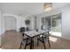 Bright dining area with a marble table, tile flooring, and sliding glass doors at 3025 Chessington Dr, Land O Lakes, FL 34638
