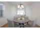 Elegant dining room with a round marble table, comfortable seating, and natural light, perfect for Gathering meals at 3025 Chessington Dr, Land O Lakes, FL 34638
