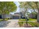 Beautiful two-story home with a well-manicured lawn and mature trees at 3025 Chessington Dr, Land O Lakes, FL 34638