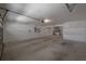 Spacious, unfinished garage with concrete floor, water heater, and utility connections at 3025 Chessington Dr, Land O Lakes, FL 34638