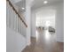 Bright hallway leading to dining and living area with light walls and tiled floors at 3025 Chessington Dr, Land O Lakes, FL 34638