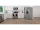 Kitchen featuring stainless steel appliances, abundant white cabinetry, and modern fixtures at 3025 Chessington Dr, Land O Lakes, FL 34638