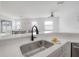 Bright, open kitchen with quartz counters and stainless steel sink overlooking the living and dining spaces at 3025 Chessington Dr, Land O Lakes, FL 34638