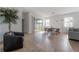 Open-concept living room featuring tile flooring, neutral tones, and lots of natural light at 3025 Chessington Dr, Land O Lakes, FL 34638