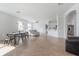 Open concept living space with bar-top seating, neutral walls, and tile floors at 3025 Chessington Dr, Land O Lakes, FL 34638