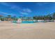 Large community pool featuring palm trees and blue umbrellas at 3025 Chessington Dr, Land O Lakes, FL 34638