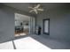 Screened-in porch with a view of the backyard and an open door to the kitchen at 3025 Chessington Dr, Land O Lakes, FL 34638