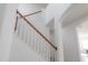 Bright staircase with white risers and natural wood handrail at 3025 Chessington Dr, Land O Lakes, FL 34638