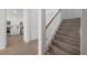 Entryway featuring tiled flooring, a staircase, and an archway leading into the kitchen at 3025 Chessington Dr, Land O Lakes, FL 34638