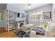 Bright living room with a coastal decor, featuring built in shelves, modern ceiling fan, and a comfortable white sofa at 303 8Th E Ave, Palmetto, FL 34221