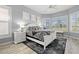 A light filled primary bedroom with bay windows, a ceiling fan, and neutral decor at 303 8Th E Ave, Palmetto, FL 34221