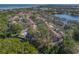 Aerial view of a home on waterway and lake with lush green landscape and bridge views at 3042 Branch Dr, Clearwater, FL 33760