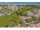 Aerial view of a home surrounded by lush greenery, waterways, and nearby bridge at 3042 Branch Dr, Clearwater, FL 33760