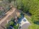 A lush tropical setting surrounds this home in an aerial view, near a scenic waterway at 3042 Branch Dr, Clearwater, FL 33760