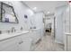 Contemporary bathroom featuring dual sinks, and a view towards the Primary bedroom at 3042 Branch Dr, Clearwater, FL 33760