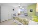 Bedroom with ceiling fan, large windows, and neutral carpeting at 3042 Branch Dr, Clearwater, FL 33760