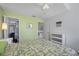 Well-lit bedroom features a ceiling fan, closet, and view into the second floor at 3042 Branch Dr, Clearwater, FL 33760