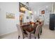 Formal dining room featuring elegant chandelier, seating for six, and seamless access to the kitchen at 3042 Branch Dr, Clearwater, FL 33760