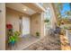 Inviting entryway featuring a white door, potted plants, and a cozy sitting area at 3042 Branch Dr, Clearwater, FL 33760