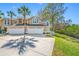 Inviting townhouse showcasing a two-car garage and tropical palm trees accenting the property at 3042 Branch Dr, Clearwater, FL 33760