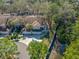 Aerial of a well-maintained townhouse with a two car garage, green lawn and waterside access at 3042 Branch Dr, Clearwater, FL 33760