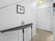Clean hallway with storage closet, display shelf, and neutral decor at 3042 Branch Dr, Clearwater, FL 33760