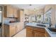 Well-lit eat-in kitchen with light wood cabinets, and a seamless connection to the backyard seating area at 3042 Branch Dr, Clearwater, FL 33760