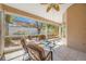 A screened-in patio has comfortable seating, offering relaxation and views of the lush backyard at 3042 Branch Dr, Clearwater, FL 33760