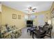 Bright living room with ceiling fan, tile flooring, and comfortable seating area at 3042 Branch Dr, Clearwater, FL 33760