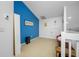 Neutral loft with vaulted ceiling and one blue accent wall at 3042 Branch Dr, Clearwater, FL 33760