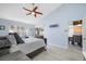 Main bedroom with vaulted ceilings, ceiling fan, large windows, and lanai access at 3042 Branch Dr, Clearwater, FL 33760