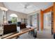 Bright office with large desk, arched window, storage shelves, and ceiling fan at 3042 Branch Dr, Clearwater, FL 33760