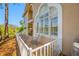 Cozy outdoor patio area featuring brick pavers, a white railing and plenty of light at 3042 Branch Dr, Clearwater, FL 33760