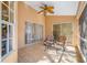 A covered patio with tile flooring, ceiling fan, and sliding doors offers comfortable outdoor living at 3042 Branch Dr, Clearwater, FL 33760
