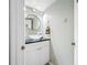 Stylish half bathroom featuring a vessel sink, sleek vanity, updated mirror and coastal decor at 3042 Branch Dr, Clearwater, FL 33760