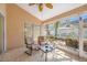 Relax in this cozy screened-in patio with ceiling fan and comfortable seating at 3042 Branch Dr, Clearwater, FL 33760