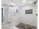 Shower boasts decorative tile, a rain shower head, and a built-in niche at 3042 Branch Dr, Clearwater, FL 33760