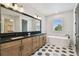 Bathroom features a soaking tub, walk-in shower, double vanity and striking tile floors at 3404 S Omar Ave, Tampa, FL 33629