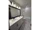 Bathroom featuring double vanity with white countertop and shower-tub combo at 3404 S Omar Ave, Tampa, FL 33629