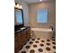 Bright bathroom featuring hexagon tile, soaking tub, and dark wood vanity at 3404 S Omar Ave, Tampa, FL 33629