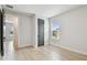 Well-lit bedroom with hardwood floors, a window, and a gray closet door at 3404 S Omar Ave, Tampa, FL 33629