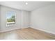 Bedroom features a window with blind and light wood flooring at 3404 S Omar Ave, Tampa, FL 33629