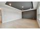 Bedroom with tray ceiling, dark accent wall and wood-look floors at 3404 S Omar Ave, Tampa, FL 33629