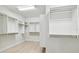 Spacious walk in closet with multiple shelves and light wood flooring at 3404 S Omar Ave, Tampa, FL 33629