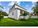 Attractive two-story home boasting a covered porch, complemented by lush landscaping and a vibrant green lawn at 3404 S Omar Ave, Tampa, FL 33629